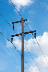 Photograph looking up at the top of a wooden telephone pole in a remote location in the Blue...