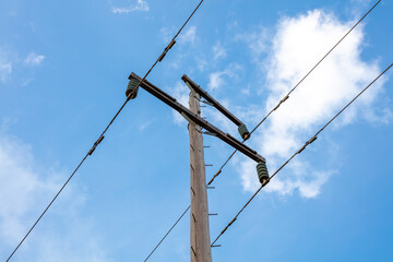 Photograph looking up at the top of a wooden telephone pole in a remote location in the Blue...