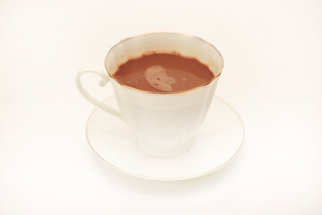 A white cup and saucer with coffee on a white background.