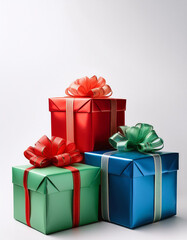 Fototapeta premium Three colorful wrapped gift boxes with ribbon bows are sitting on a white background for a holiday or birthday celebration