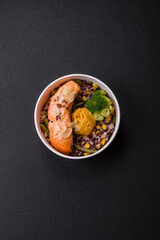 A piece of boiled salmon with rice, broccoli, salt and spices