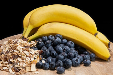 Muesli Blueberries and Bananas served on a wooden board