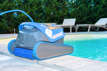 Automatic Pool Cleaner by the Poolside with Garden Background