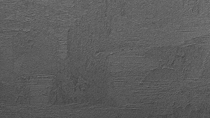 Dark grey wall abctract texture background with a few scratches and marks. The wall is very plain and has no decoration