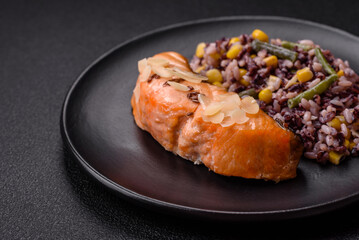 A piece of boiled salmon with rice, broccoli, salt and spices