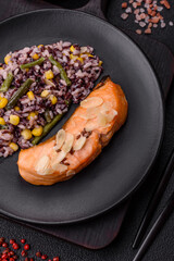 A piece of boiled salmon with rice, broccoli, salt and spices