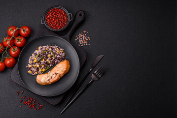 A piece of boiled salmon with rice, broccoli, salt and spices