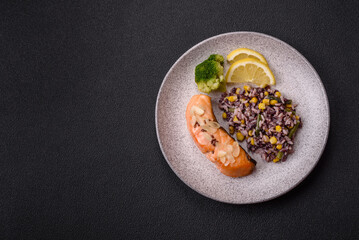 A piece of boiled salmon with rice, broccoli, salt and spices