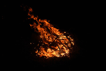 bonfire in the dark, burning branches in the flames of fire at night