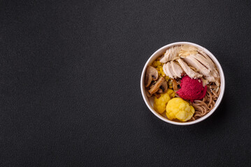 Asian dish with sliced chicken fillet, buckwheat noodles, soy sauce