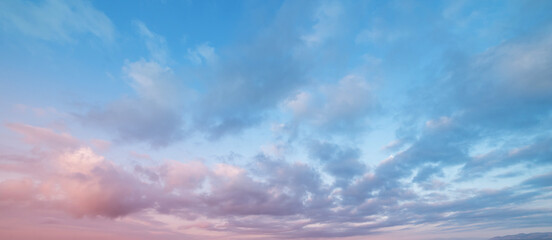 Beautiful tender sunrise sky with clouds. Sky background. 