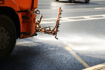 municipal truck cleans the road with powerful jets of water, showcasing urban maintenance and environmental care in action, ensuring cleanliness and safety for all