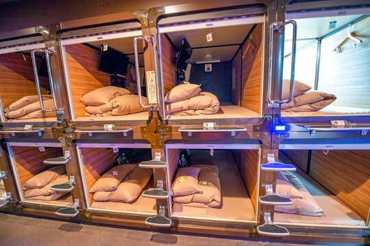 Tokyo, Japan - June 1st, 2016: Interior of Capsule Hotel with tiny rooms for guests along a long corridor