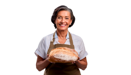 A joyful senior baker, isolated on a clear background, holds up a delicious loaf of bread while wearing a baker's apron.