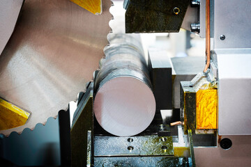 A close up of a saw blade with a red handle. The blade is sharp and ready to cut
