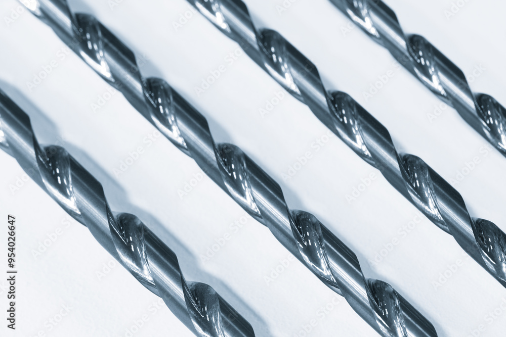 Poster multiple hammer drills hanging on a white shelf at the hardware store, industrial tool concept backg