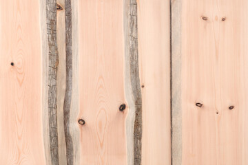 A wooden surface with a grainy texture background and a few holes. The wood appears to be old and weathered, giving the impression of a natural, rustic feel