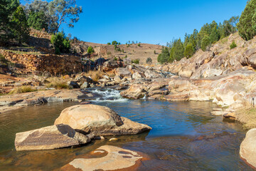 Photograph of water flowing in Adelong creek near the Adelong Falls Gold Mine ruins in the Snowy...