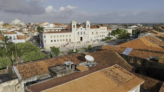 Drone flies backwards from Igreja do Carmo church in historic center out to Anil River in Sao Luis, Maranh&atilde;o, Brazil