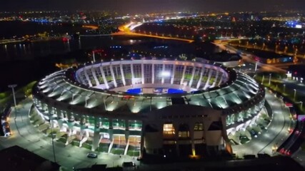 Witness a thrilling soccer match at a stadium packed with passionate fans, Aerial View of Soccer Stadium at Night - Powered by Adobe