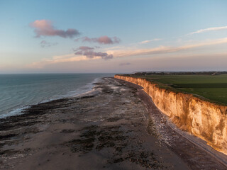 West coast of France. Clifs of Etreta. Sunset. Etretat village, Normandy region.