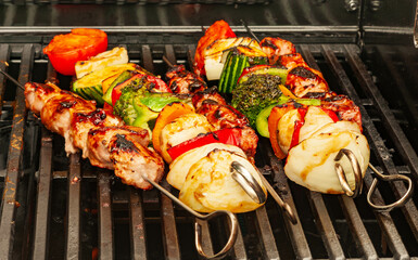 barbecue meal of grilled vegetables and meat on skewer - shallow DOF