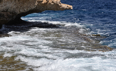 waves crashing on rocks of the sea