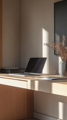 A desk with a laptop and a picture of a plant on it