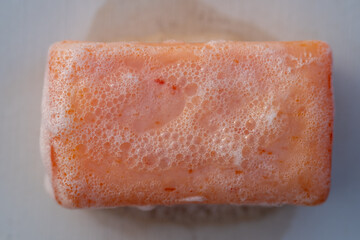 White soap bubbles surrounding an orange object