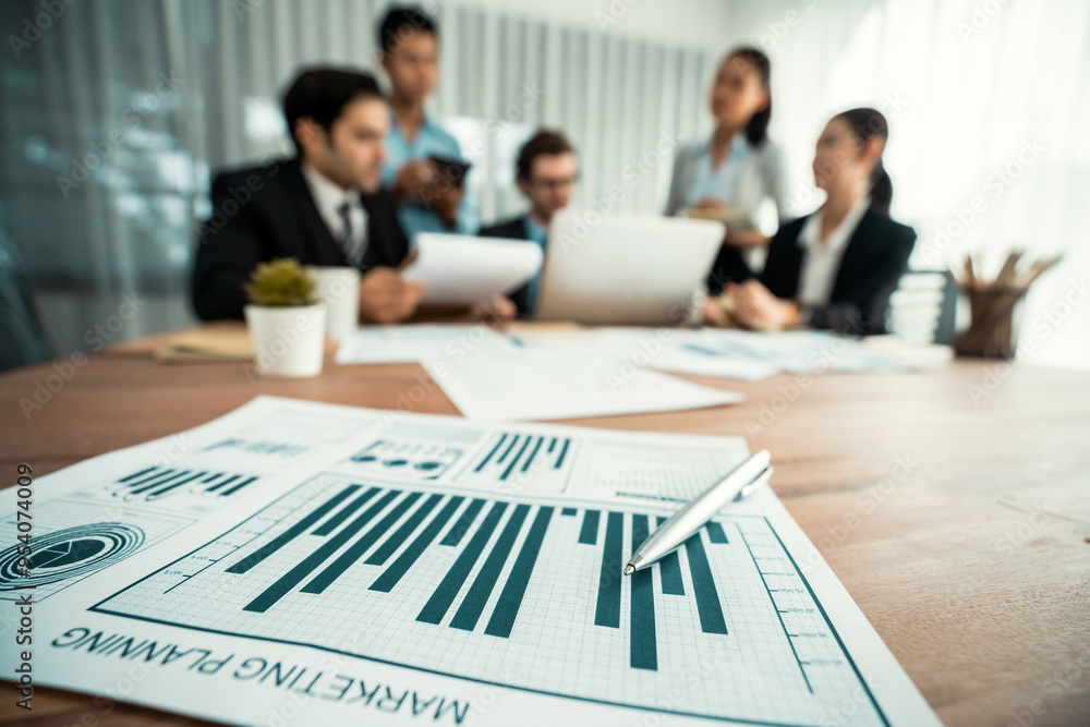 Aufkleber piles of analyzed financial data dashboard on meeting table with background of business people analy