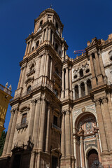 Fototapeta premium Architectural fragments of Malaga Cathedral facade. Renaissance Cathedral - Roman Catholic Church in the city of Malaga, was constructed between 1528 and 1782. Malaga, Costa del Sol, Andalusia, Spain.