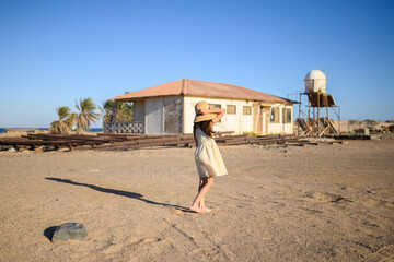 Small girl walking on the beach