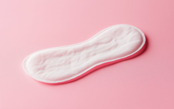 Women's sanitary pad on a pink background, which creates a feeling of calm and softness
