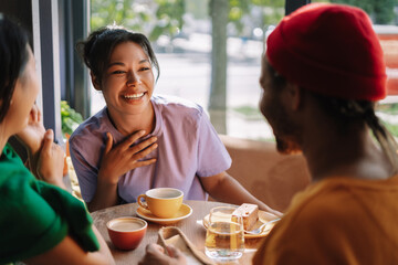 Multiracial friends group enjoying coffee break together in cafe