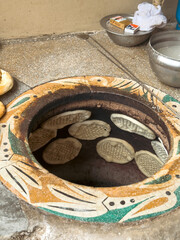 Famous Pakistani naan baking in tandoor, Lahori kulcha