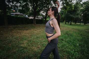 A young girl dances elegantly in a park, surrounded by greenery and trees, embodying freedom and serenity in a natural setting.