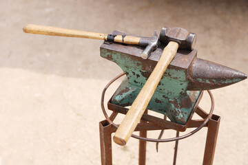 Farrier tools close up view at rural horse farm. Equestrian life. Equipments and hammer rest on the...