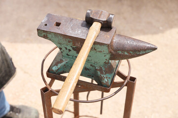 Farrier tools close up view at rural horse farm. Equestrian life. Equipments and hammer rest on the...