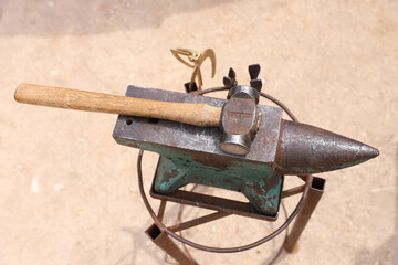 Farrier tools close up view at rural horse farm. Equestrian life. Equipments and hammer rest on the...