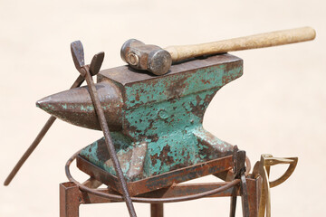 Farrier tools close up view at rural horse farm. Equestrian life. Equipments and hammer rest on the...