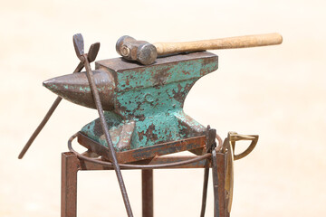 Farrier tools close up view at rural horse farm. Equestrian life. Equipments and hammer rest on the...