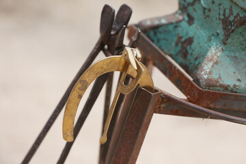 Farrier tools close up view at rural horse farm. Equestrian life. Equipments and hammer rest on the...