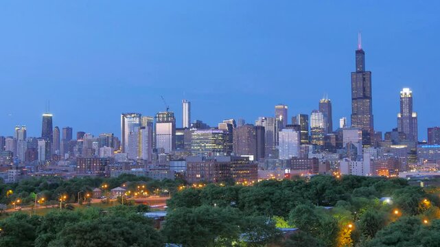 This timelapse showcases the transition from day to night, revealing the stunning Chicago skyline as the city lights gradually illuminate the buildings and streets. The iconic Willis Tower