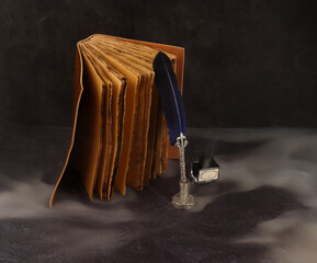 diary or antique notebook in leather or leather recycled sheets and ink vote with blue and smoke pen, photo in vertical with space for text