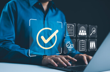 Digital quality control and certification concept. Businessman working on a laptop with icons quality control, certificate, and assurance. Checkmark symbol, success verification, standard compliance,