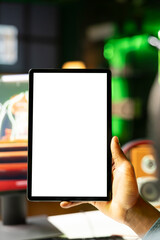 Close up shot of mockup tablet held by man in neon lit apartment while playing videogame on gaming PC. Isolated screen portable device used by person in RGB illuminated home © DC Studio