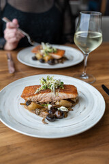 Salmon dinner with woman at a romantic restaurant