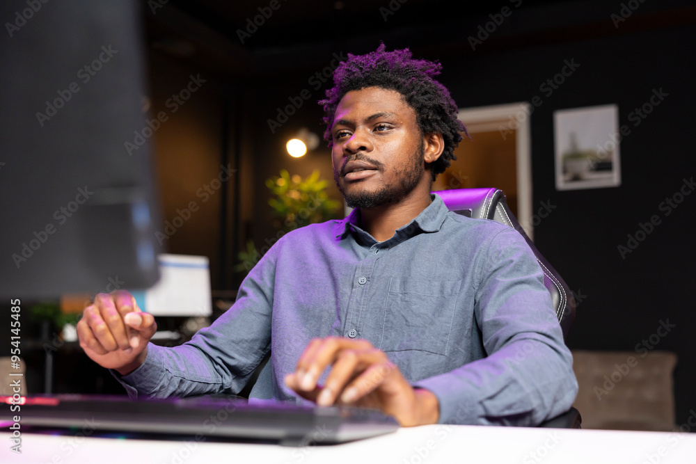 Poster gamer playing videogames on computer desktop late at night, struggling to stay awake. man using pc k