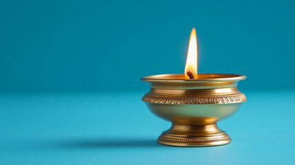 Happy Diwali, Brass Diya Lit Against a Blue Background, Space for Text, Indian Festival