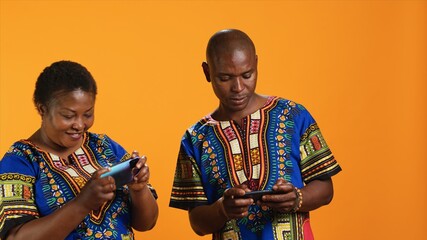 Obraz premium Cheerful woman winning videogames contest with boyfriend, feeling happy about tournament victory. Husband and wife playing online mobile games together, enjoying leisure activity,